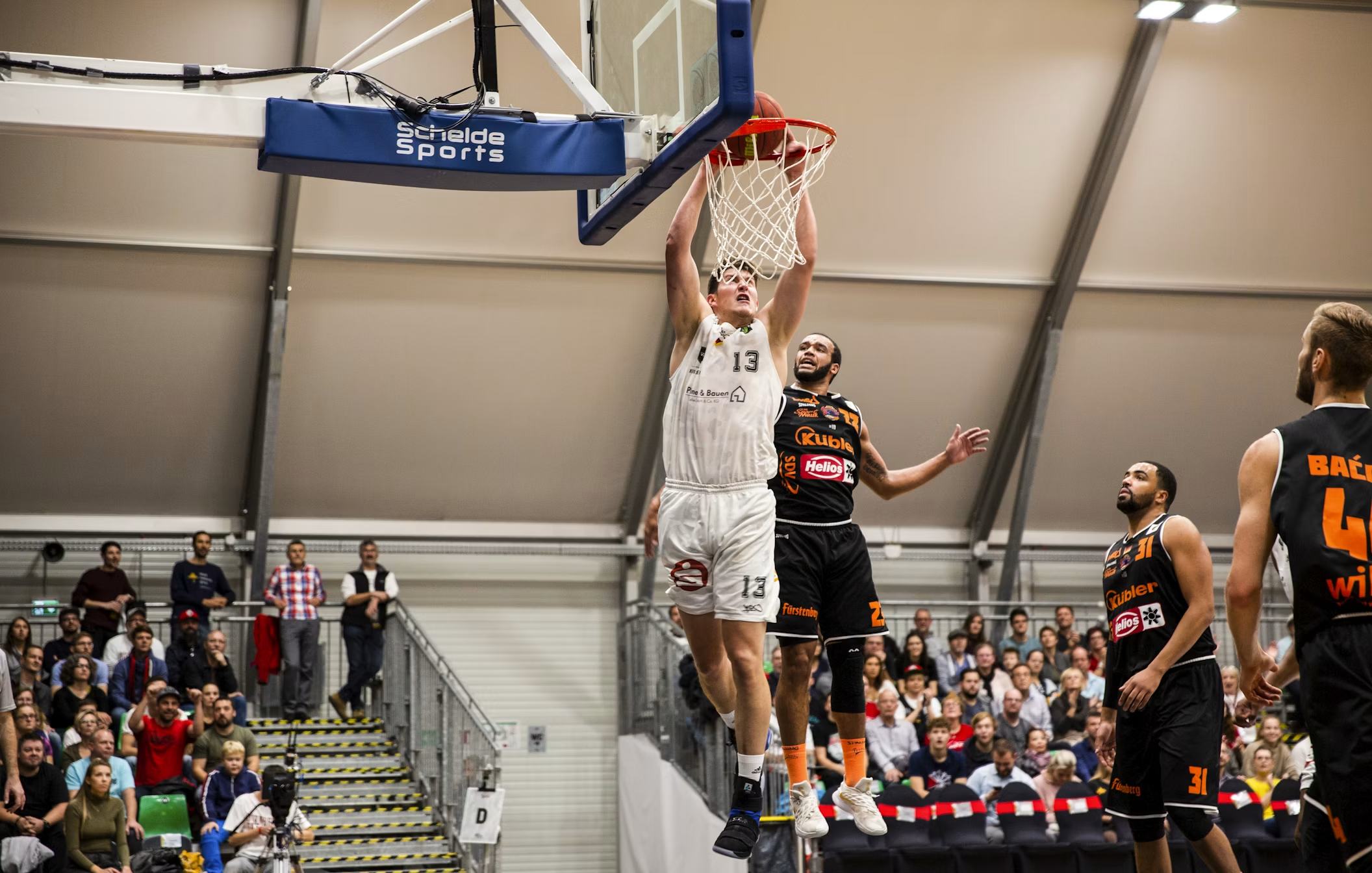 Basketball players competing at the hoop